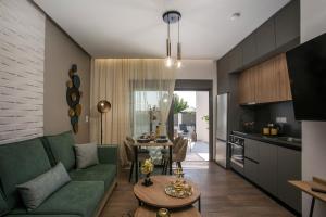 a living room with a green couch and a table at Maro Luxury Villa in Afantou