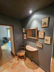 a room with a table and a mirror on a wall at Le Gîte de Mc Adam in Lavardin +9 photos