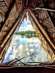 a view of the water from a straw hut at La Isla Dulce in Lívingston +17 photos