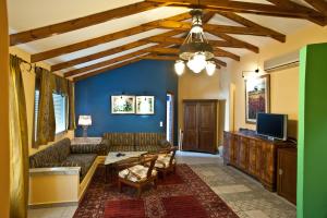 a living room with a couch and a tv at Akti in Nafpaktos