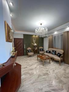 a living room with furniture and a chandelier at Balcony With A View in Nafplio