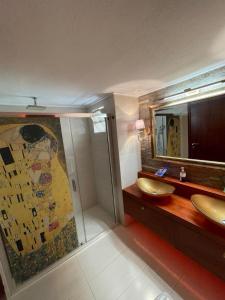 a bathroom with two sinks and a large mirror at Balcony With A View in Nafplio