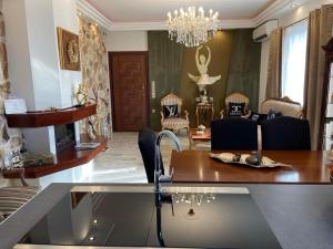 a living room with a table and a dining room at Balcony With A View in Nafplio