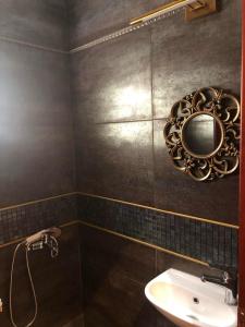 a bathroom with a sink and a mirror on the wall at Balcony With A View in Nafplio