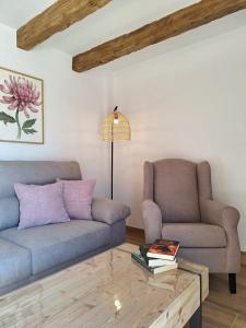 a living room with two couches and a coffee table at La Palmera Casa Rural in L'Aldea +39 photos
