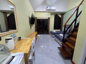 a living room with a couch and stairs in it at Khumkatang Resort & Restaurant in Ban Bang Rong +65 photos