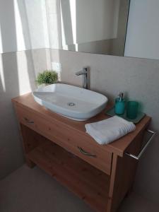 a bathroom with a sink and a mirror at Casa Agricola Amicizia in Poiana Maggiore +15 photos