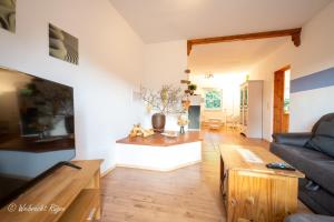 a living room with a couch and a table at Ferienhaus Luppath in Poseritz