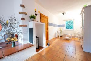 a living room with a tile floor and a fireplace at Ferienhaus Luppath in Poseritz
