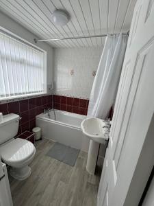a bathroom with a toilet and a sink and a bath tub at Luna Apartments Newcastle Gateshead 1 in Gateshead +18 photos