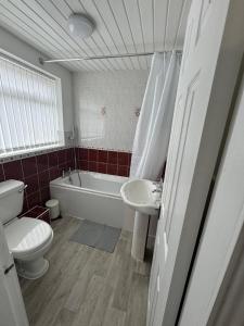 a bathroom with a toilet and a sink and a tub at Luna Apartments Newcastle Gateshead 1 in Gateshead
