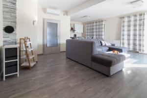 a living room with a couch and a table at Villa Nicolle in Privlaka