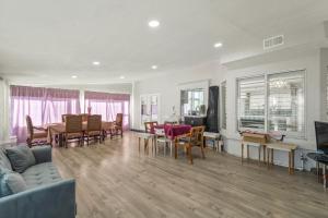 a living room with a couch and a table and chairs at Near Airport and Outlet Mall 6 bedroom large house in Ontario