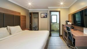 a hotel room with a large bed and a desk at Americas Best Value Inn, Antioch in Antioch