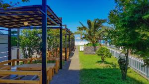 a row of benches in a park next to the beach at Batumi-Gonio Mgzavrebi Apartmant in Gonio