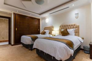 a hotel room with two beds in a room at جناح خاص في أجنحة طيبة in Medina