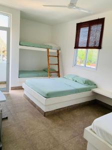 a bedroom with two bunk beds and a window at Casa Caracola in Hawaii