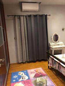 a room with a bed and a rug on the floor at Balcony With A View in Nafplio