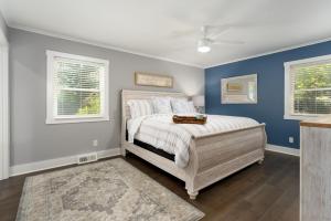 a bedroom with a bed and two windows at Peace of Happiness Coastal Cottage 7 mi from Wrightsville Beach, NC in Windemere +66 photos