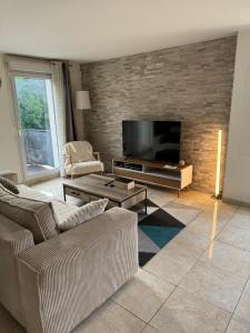a living room with two couches and a flat screen tv at Appartement duplex T3 avec box - Paris - La Défense - Airport CDG - Parc des expositions - Stade de France - Disney - Astérix - Val D Europe in Villepinte