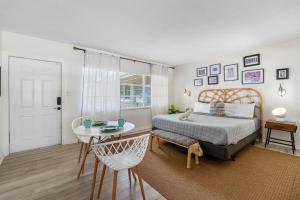 a bedroom with a bed and a table and a chair at St Pete Boho Getaway Walk to Pier and Beach in St. Petersburg +74 photos