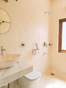 a bathroom with a sink and a toilet at Tuscan Breeze, Nandi Hills in Nandigunda +58 photos