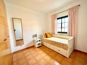a bedroom with a bed with a mirror and a window at Casa Pepe Las Candelarias in Agaete