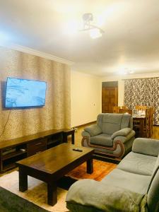 a living room with a couch and a table at Tevody Heights in Nairobi