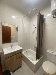 une salle de bain avec un lavabo, une baignoire et des toilettes dans l'établissement Turia Gardens Rooms - Authentic Valencia Parklife Downtown - VLC Urban Rental, à Valence
