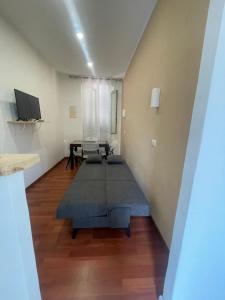 a living room with a table and a couch at Casa di Ale in Tivoli
