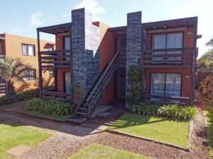 a house with a staircase in front of it at Las Pakas in La Paloma