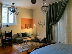 a bedroom with a bed and a couch and a table at Tiramisù in Tivoli