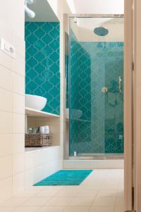 a bathroom with a shower with blue tiles at Tiramisù in Tivoli +11 photos
