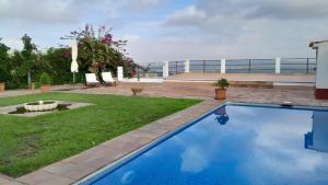 a swimming pool in the yard of a house at Az-zait in Aznalcázar