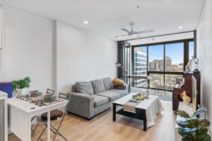 a living room with a couch and a table at breathtaking Fortitude valley Apartment in Brisbane