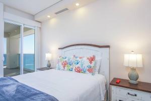 ein Schlafzimmer mit einem großen weißen Bett und einem Fenster in der Unterkunft Encantame Towers 2 -Bedroom Luxury DLX Verano E905- Corner Balcony in Playa Encanto + 25 Fotos