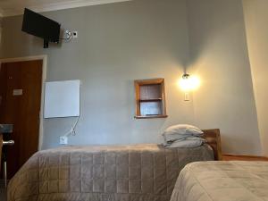 Postel nebo postele na pokoji v ubytování Merrylees Hotel