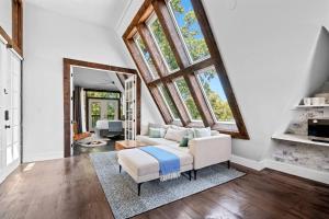 ein Wohnzimmer mit Couch und großem Fenster in der Unterkunft Luxury escape in DC, with a private Deck! Parking included in Washington