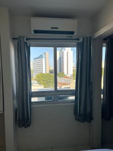 a window in a room with a view of a city at Recife - Boa Vista in Recife