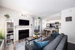 a living room with a couch and a fireplace at Studio Condo @ North Creek|Pool/Hot Tub/Crave TV in Blue Mountains