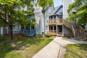 a house with a porch and a staircase in a yard at Studio Condo @ North Creek|Pool/Hot Tub/Crave TV in Blue Mountains