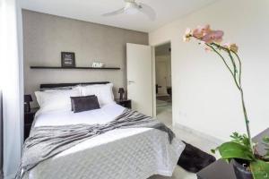 Ένα ή περισσότερα κρεβάτια σε δωμάτιο στο Apartamento em Itapema