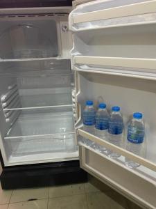 an open refrigerator with bottles of water in it at Saran Hotel krabi Thailand in Krabi