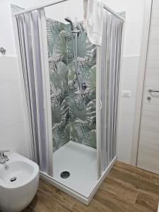 a shower in a bathroom with a toilet and a sink at Onda Blu in Agropoli