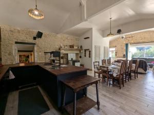 a kitchen and dining room with a table and chairs at Maison familiale avec piscine privée et jardin pour 11 pers - FR-1-653-265 in Magnac-Lavalette