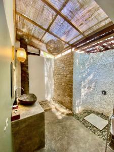 a bathroom with a sink and a glass wall at LUCKY'S in Gili Islands +38 photos