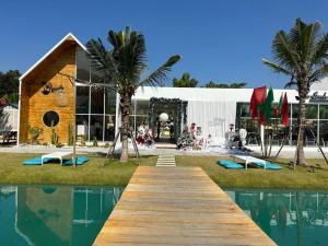 a building with a wooden dock next to a pool at Self Check in 10min to BKKairport Train2Town Near Mall Local Market WIFI in Bangkok