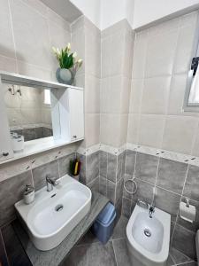 a bathroom with a sink and a toilet at AURI'S HOUSE in Vlorë +18 photos