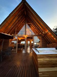 a large wooden deck with a hot tub on it at ThanSam Cabaña in San Vicente +11 photos