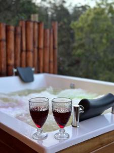 two glasses of wine sitting in a bath tub at ThanSam Cabaña in San Vicente